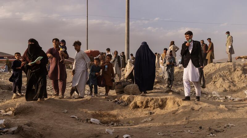 People gather in a field outside the military side of Hamid Karzai International Airport in Kabul on August 23rd. Photograph: Victor J Blue/New York Times