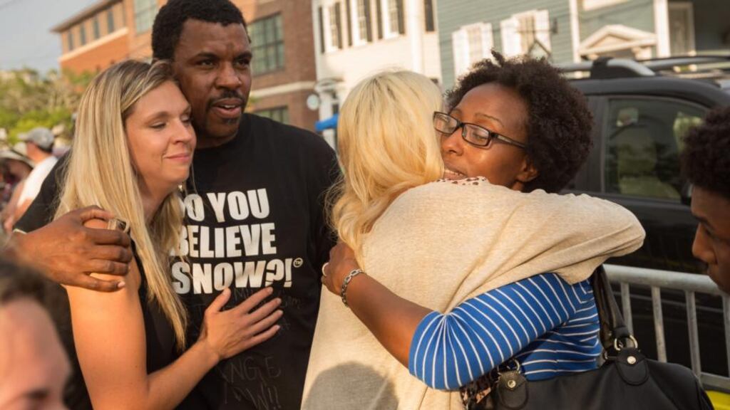 Charleston residents grieve at a makeshift memorial outside the historic mother Emanuel African Methodist Episcopal Church to honor the nine victims slain by alleged killer Dylann Roof in Charleston, South Carolina. Photograph: Richard Ellis/EPA