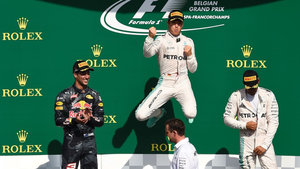 Mercedes driver Nico Rosberg celebrates winning the Belgian Grand Prix next to second placed Daniel Ricciardo of Red Bull and team-mate Lewis Hamilton in third. Photograph: John Thys/AFP/Getty Images