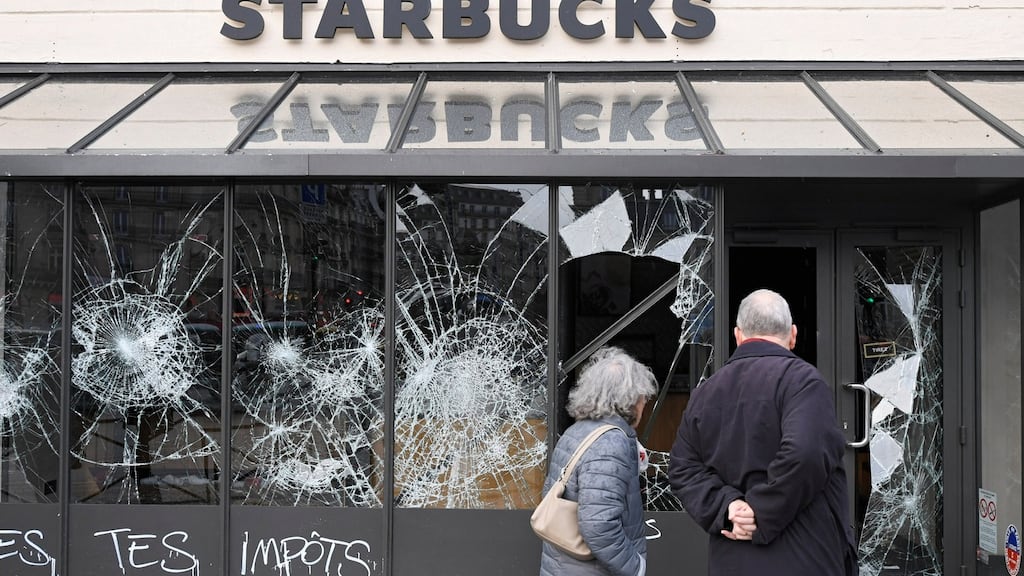 Graffiti is seen on a vandalised Starbucks coffee shop following protests in Paris, France. Photograph: REUTERS/Piroschka van de Wouw