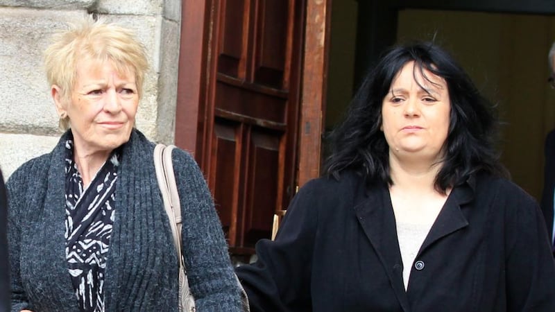 Lydia Acton of St John’s Grove, Clondalkin, Dublin, leaves the Four Courts today with her daughter, Lisa, after a High Court action over her husband’s death in hospital. Photograph: Collins Courts