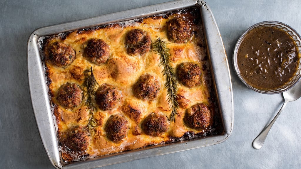 Yotam Ottolenghi’s meatball toad-in-the-hole incorporates well-cooked meat, a crisp pancake and velvety gravy. Photograph: Andrew Scrivani/New York Times