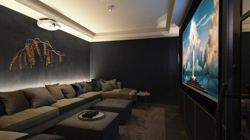 Chic home cinema in dark tones and extended sofa seating