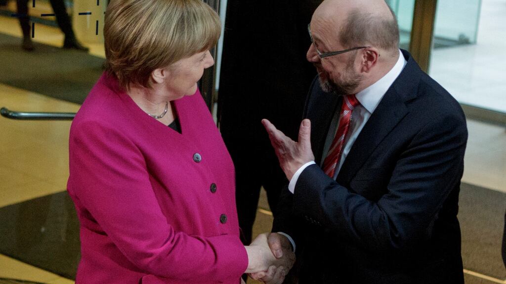 Martin Schulz (R), head of the German Social Democrats (SPD), welcomes German chancellor Angela Merkel at the headquarters of the SPD for preliminary coalition talks. Photograph: Carsten Koall/Getty Images