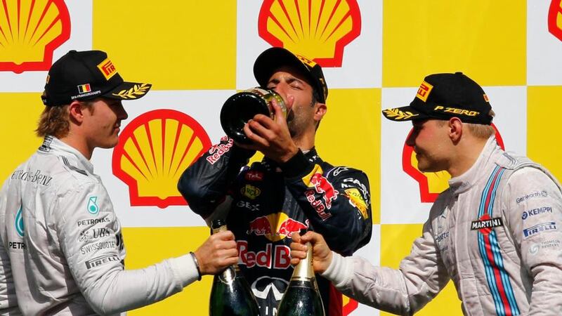 Red Bull’s Daniel Ricciardo of Australia (centre) celebrates with champagne after winning the Belgian F1 Grand Prix in Spa-Francorchamps ahead of Valtteri Bottas (right) in third and Nico Rosberg (left) in second . Photograph: Yves Herman / Reuters