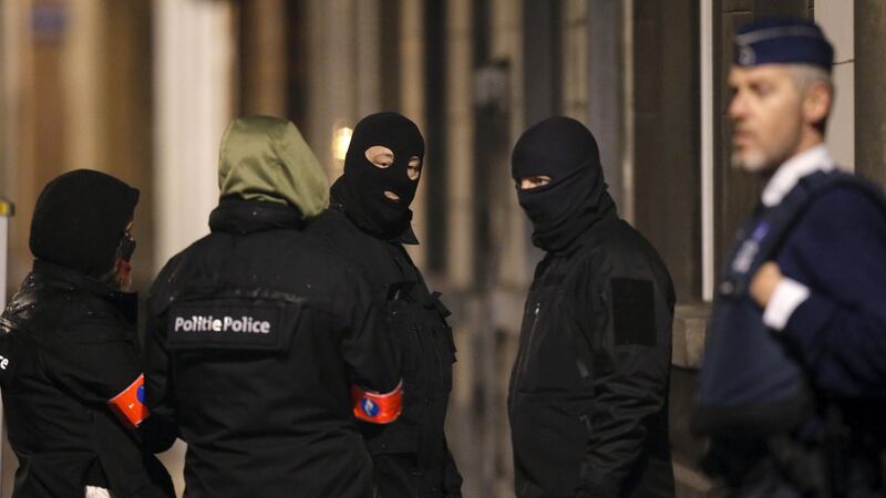 Masked Belgian police in Schaerbeek. Photograph: Christian Hartmann/Reuters