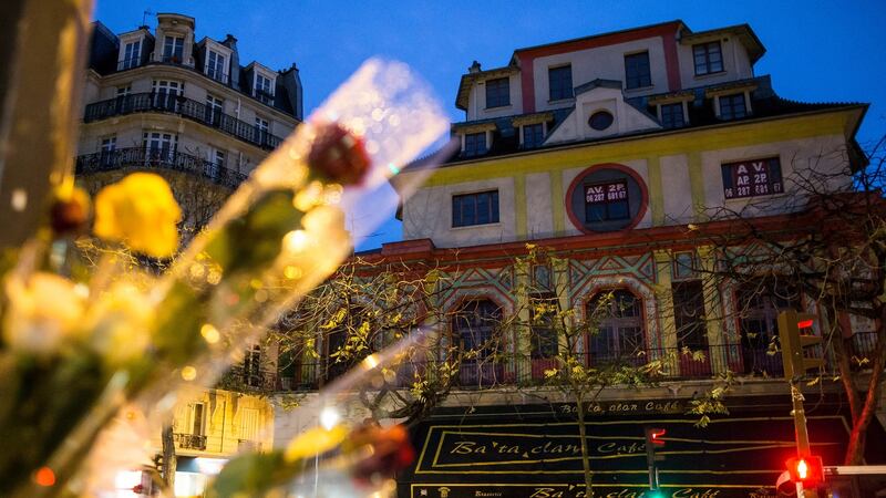 Roses adorn lamp-posts across the Bataclan concert venue, where terrorists killed 89 people in Paris. Photograph: Ian Langsdon/EPA