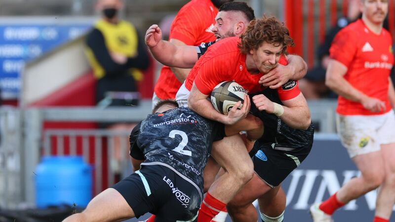 Munster’s Ben Healy is tackled by the Osprey’s Ifan Phillips and Gareth Thomas. Photograph: Billy Stickland/Inpho