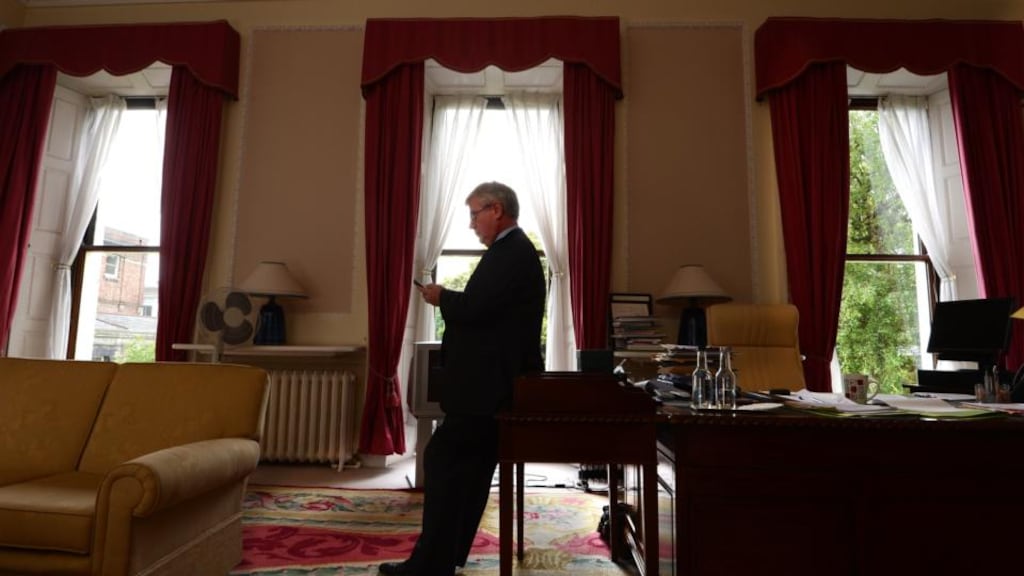 Tánaiste Eamon Gilmore checking his phone at the Department of Foreign Affairs yesterday. Photograph: Cyril Byrne/The Irish Times