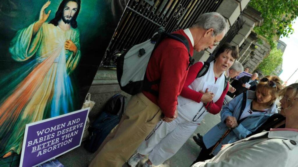 People gather outside the Dáil on Kildare Street t the beginning of the debate on the Protection of Life during Pregnancy Bill. Photo: Clodagh Kilcoyne