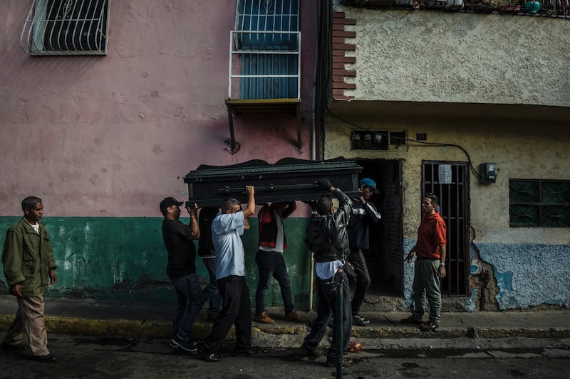 Pallbearers carried the coffin of Victor Martínez, 47, who died of tuberculosis last month in Petare, Venezuela.