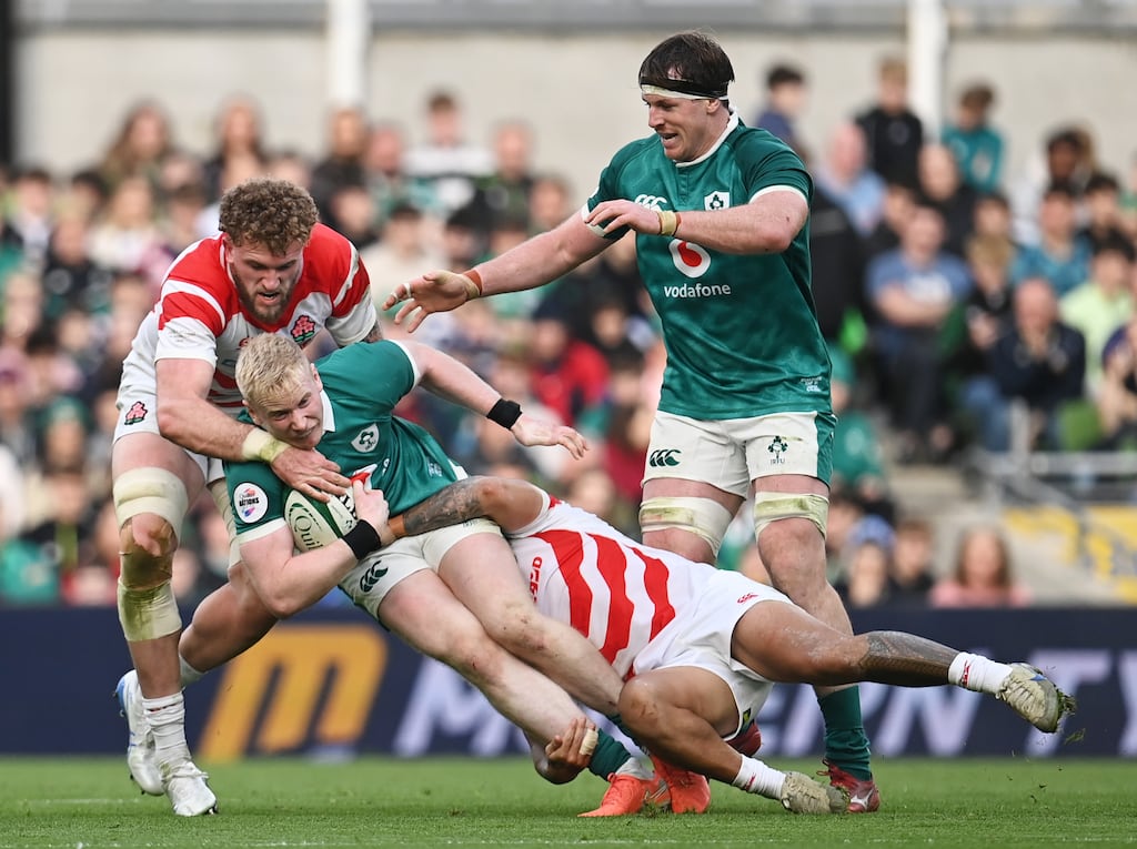 Jamie Osborne of Ireland is tackled by Charlie Lawrence and Warner Dearns of Japan. Photograph: Charles McQuillan/Getty