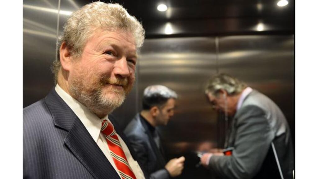 Minister for Health James Reilly smiles as two Department of Health officials attempt to open the door of a lift in which they became stuck at a mental health facility on the old Grangegorman site in Dublin. Photograph: Brenda Fitzsimons/Irish Times