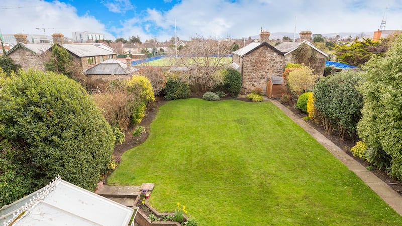The 90ft-long back garden is mainly in lawn, bordered by mature bushes.