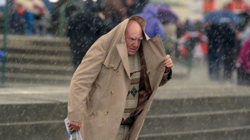Punters at the Galway Races attempt to take shelter from the rain. Photograph: Cyril Byrne
