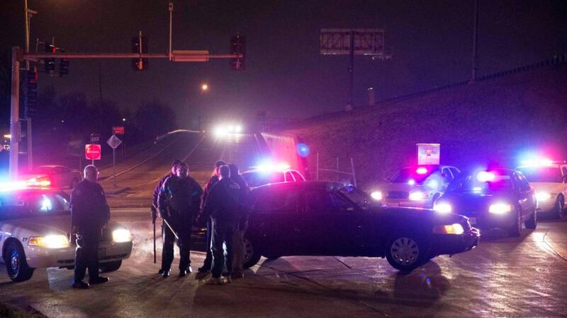 Police officers guard a highway onramp, during a protest. Black officials in Missouri were at pains to distinguish the death of a suspect they said had a gun from cases where unarmed black men were killed by police officers, incidents that led to protests across the United States and bitter debate about how American police forces treat non-white citizens. Photograph: Aaron P Bernstein/Reuters