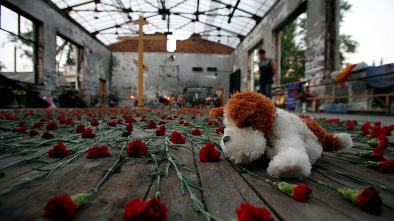 A toy amid flowers in the burned-out gymnasium of the Beslan school, the scene of a 2004 hostage crisis. Photograph: Eduard Korniyenko
