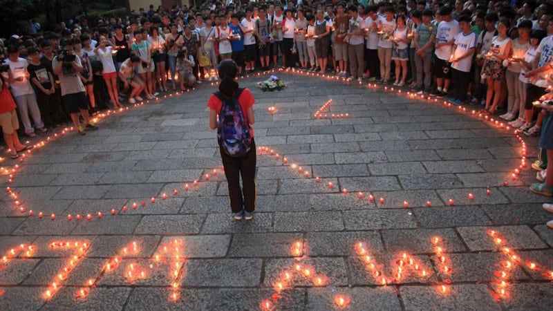 Students of the Jiangshan Middle School light candles to form a heart shape and initials, of the victims Yang Mengyuan and Wang Linjia of the Asiana Airlines crash. Photograph: Reuters
