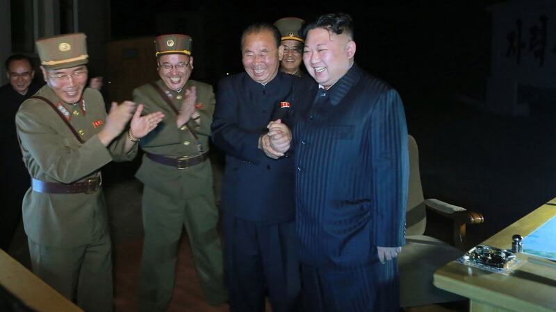Kim Jong-Un (R) celebrating a test launch of an intercontinental ballistic missile, Hwasong-14 at undisclosed place in North Korea. Photograph: KCNA news agency/Getty IMages