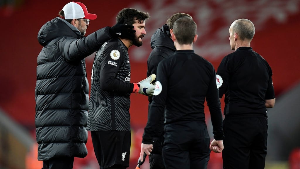 Liverpool goalkeeper Alisson is pulled away by his manager Jürgen Klopp as he speaks to the officials after the Premier League loss to Burnley at Anfield. Photo: Peter Powell/PA Wire