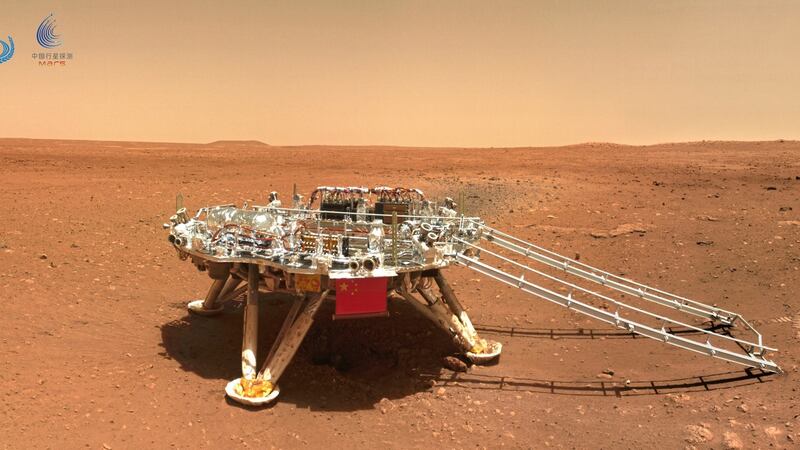 The landing platform with a Chinese national flag and outlines of the mascots for the 2022 Beijing Winter Olympics and Paralympics on Mars is seen from the rover Zhurong. Photograph: CNSA via AP