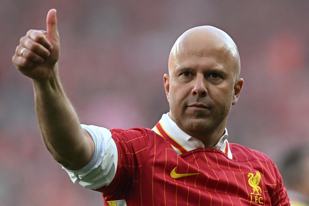 Liverpool manager Arne Slot waves to the fans after the victory over Tottenham Hotspur secured the Premier League title in his first year in charge. Photograph: Paul Ellis/AFP via Getty Images