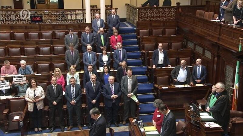 TDs Ruth Coppinger and Mick Barry hold signs saying “Separate church and state” during Dáil prayers. Photograph: RTÉ/Oireachtas TV