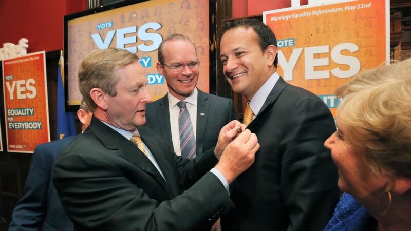 Taoiseach Enda Kenny pins a Yes badge onto Minister for Health Leo Varadkar watched by Jerry Buttimer TD, Minister for Agriculture Simon Coveney and Minister for Justice Frances Fitzgerald during the launch of Fine Gael’s campaign for a Yes vote in the forthcoming Marriage Equality Referendum in Dublin last month. Photograph: Collins