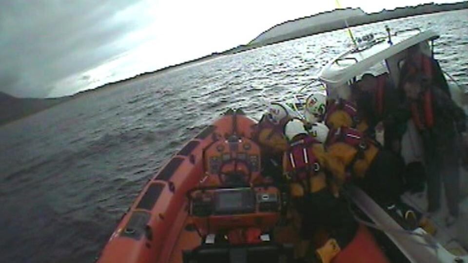 Man  is taken from a local fishing vessel and transferred onto the lifeboat. Image: Lough Swilly RNLI