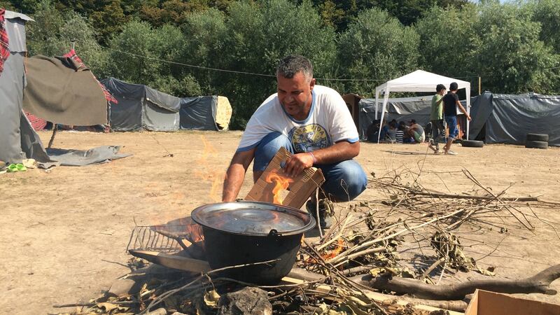 A man cooks at a camp in Velika Kladusa, near Bosnia’s border with Croatia, now home to hundreds of migrants. Photograph: Daniel McLaughlin