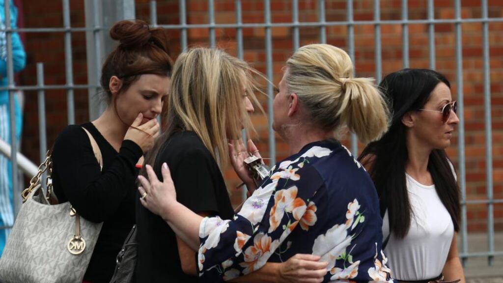Family members of Dale Creighton embracing each other as seven people appeared before court earlier this year. Photograph: Collins Dublin