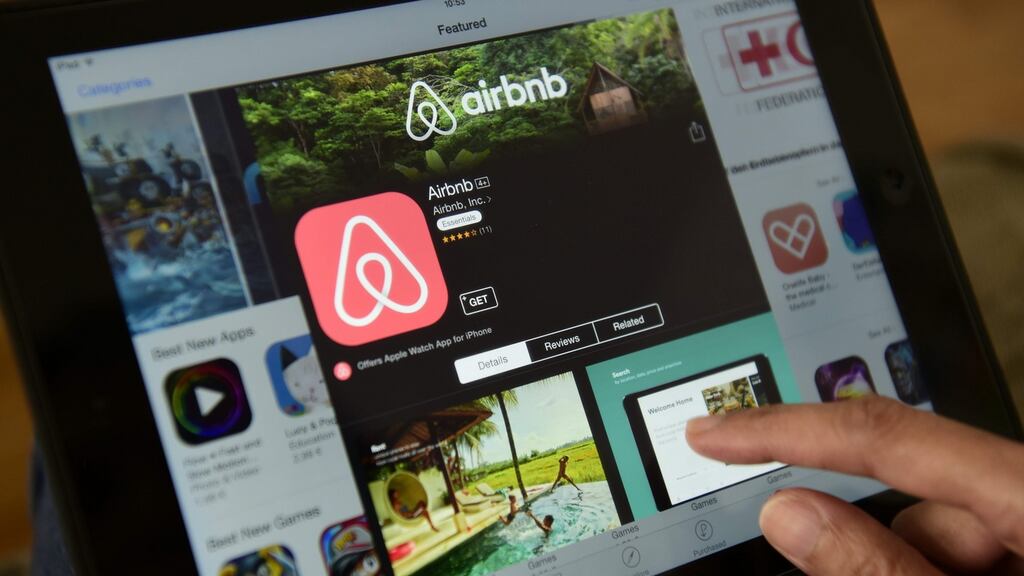 A woman browsing the site of US home sharing giant Airbnb on a tablet.