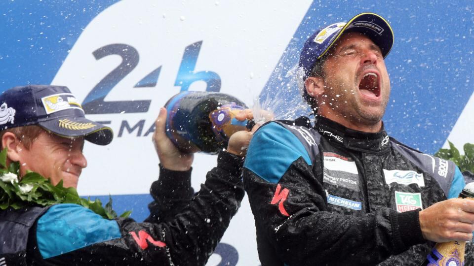 Actor Patrick Dempsey celebrates with fellow driver Marco Seefried after their Porsche 911 RSR finished at second in the GTE Amateur class at Le Mans