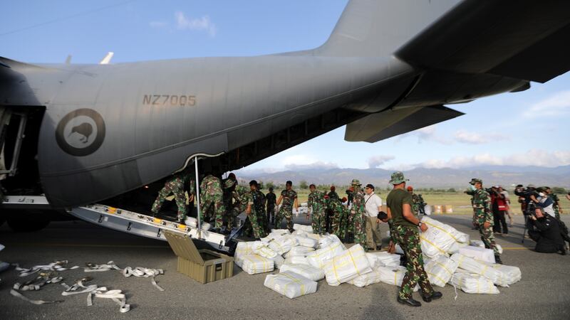 New Zealand and Australia military joined team personnel and Indonesia Military personnel unload logistic aid from a New Zealand military plane. Photograph: Hotli Simanjuntak/EPA