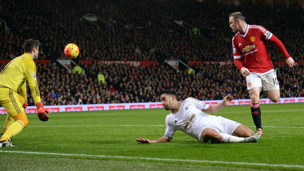 Manchester United’s Wayne Rooney flicks home from close range to give his side a 2-1 win over Swansea City in the Premier League. Photo: Oli Scarrf/Getty Images