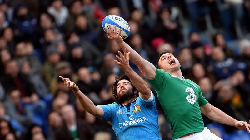 Ireland’s Tommy Bowe jumps for the ball with Italy winger Luke McLean during the sides’ Six Nations match at the Stadio Olimpico in Rome. Photograph: Filippo Monteforte/AFP/Getty Images