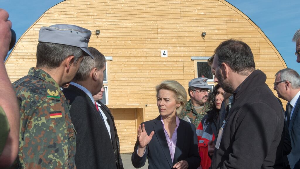 Germany’s defence minister Ursula von der Leyen at an asylum waiting centre: Angela Merkel has defended her open-door policy. Photograph: Armin Weigel/EPA