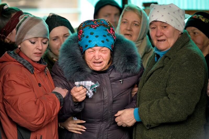 The mother of Russian army soldier Rustam Zarifulin, who was killed fighting in Ukraine, cries surrounded by relatives during a farewell ceremony in his homeland in Kara-Balta. Photograph: Vladimir Voronin/PA