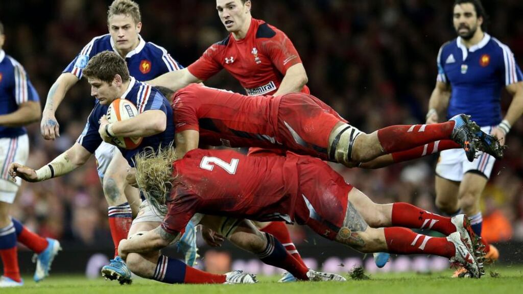 Wales’ Richard Hibbard and Taulupe Faletau tackle Pascal Pape of France. Photograph: James Crombie/Inpho