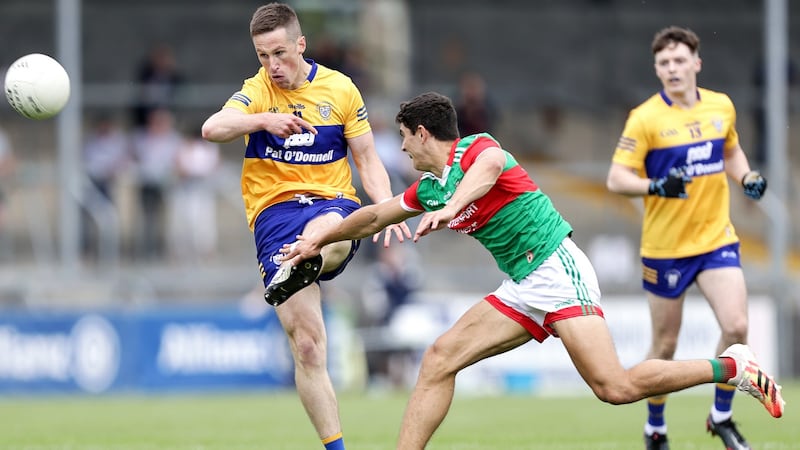Clare’s Eoin Cleary scores a point despite an attempted block from Oisín Mullin of Mayo during the Allianz Football League Division 2 semi-final at Cusack Park in Ennis in June. Photograph: Laszlo Geczo/Inpho