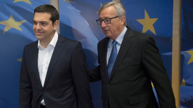 Greek Prime Minister Alexis Tsipras (left) walks next to European Commission President Jean-Claude Juncker ahead of today’s meetings. Photograph: Olivier Hoslet/Reuters