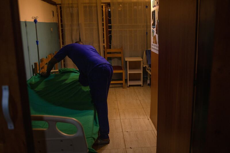 A worker at Kampala's COSF Medical Center, which provides sexual health care for LGBTQ+ patients, prepares an admission room. Photograph: Stuart Tibaweswa/The New York Times