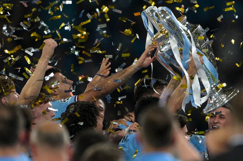 Manchester City team members hold aloft the European Cup trophy as they celebrate winning the UEFA Champions League final against Inter Milan at the Ataturk Olympic Stadium in Istanbul on Saturday. Manchester City won 1-0. Photograph: Ozan Kose/AFP/Getty