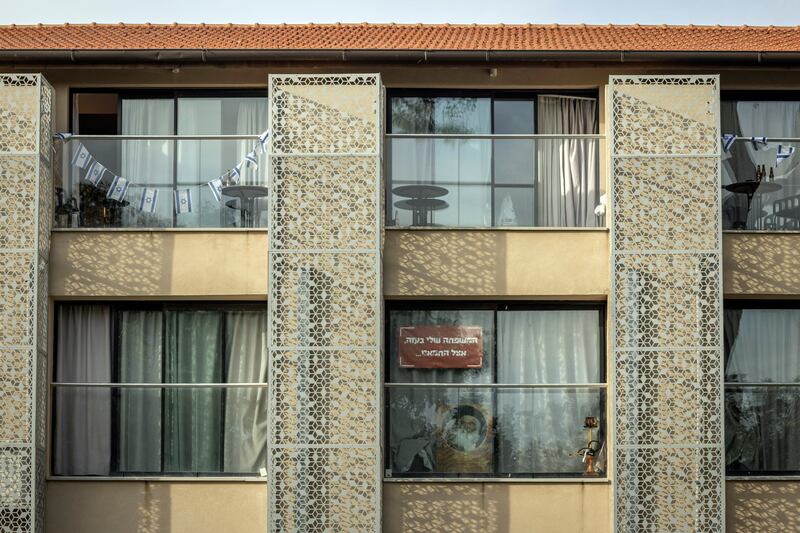 A sign in Hebrew reading 'My family is with Hamas in Gaza', a reference to hostages taken to Gaza after the October 7th attack by Hamas, hangs in a window at a hotel in Shefayim, Israel, used for housing survivors. Photograph: Avishag Shar-Yashuv/New York Times