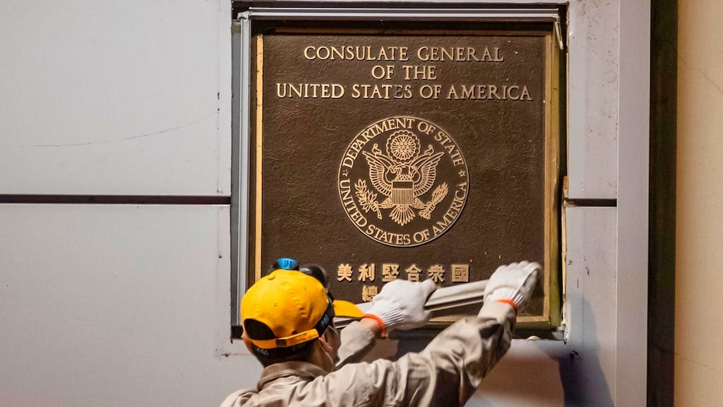 A worker attempting to remove a plate from the front of the US consulate in Chengdu, Sichuan province, China, on July 26th. Photograph: EPA/Alex Plavevski