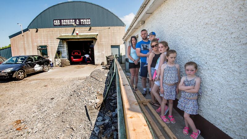 John Paul Doyle with his wife Frances and five of their six children in the back garden of the house offered to them by Longford County Council in June. Photograph: Brenda Fitzsimons/The Irish Times