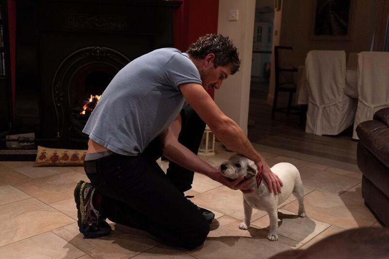 Andrew Keane performs the cure for ringworm on a dog in a neighbouring house