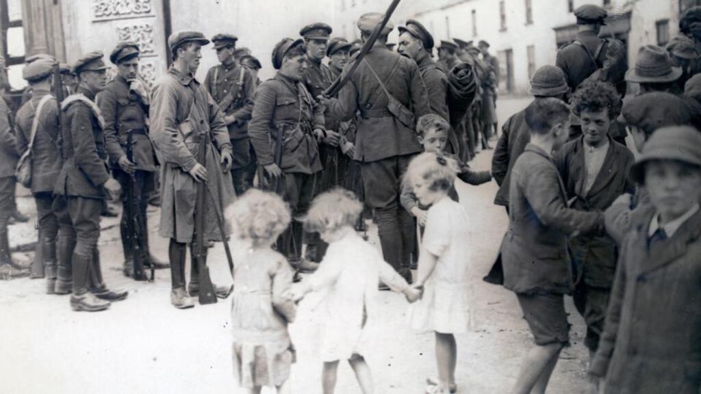 Atlas of the Irish Revolution: the book includes this image of National Army soldiers and barefoot children after the taking of Bruff, Co Limerick, from the IRA in August 1922. Photograph courtesy of the National Library of Ireland