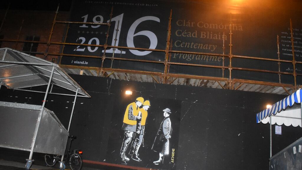 The mural depicts Patrick Pearse surrendering to British army officers dressed as contemporary building workers. Photograph: John Rooney