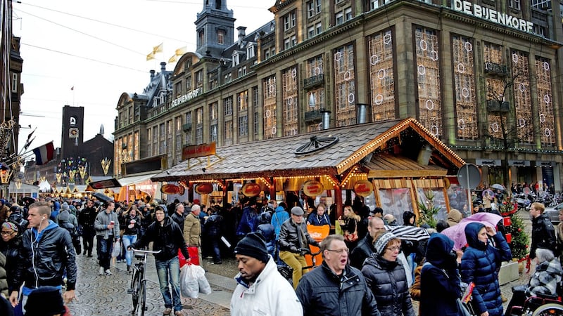 People shop at a Christmas market in the centre of Amsterdam. Photograph: Robin Utrectht/AFP/Getty